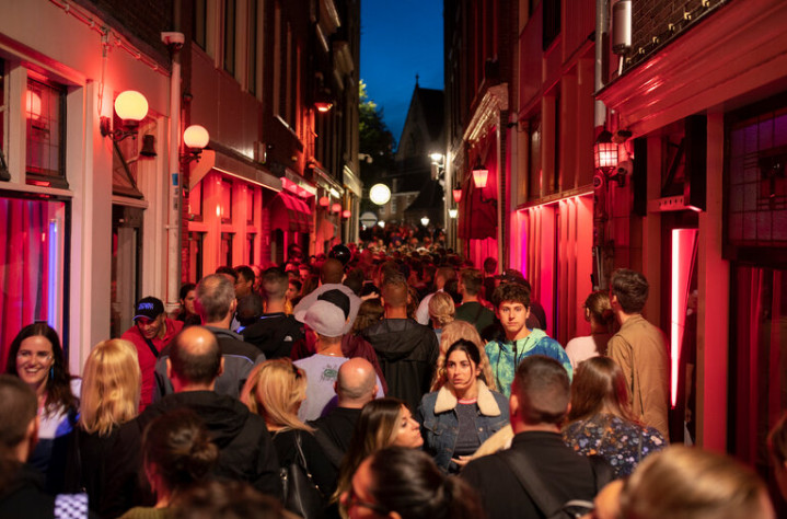 Crowded Amsterdam street near the Red Light District showing tourist safety tips for 2025 visitors